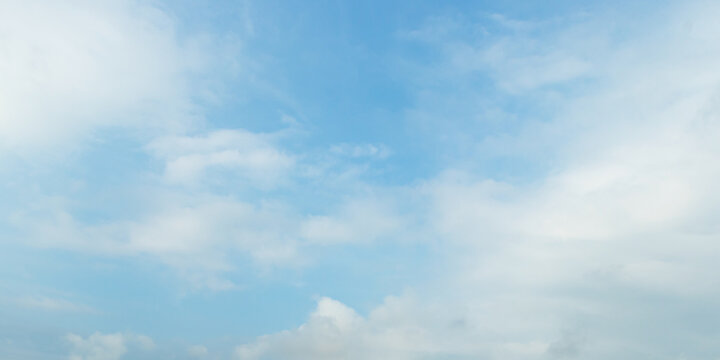 Panoramic vibrant blue sky background with soft white clouds and bright daylight for natural backdrop and clean outdoor design