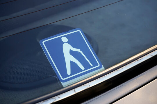 Senior driver car sticker with international elderly person icon with white cane on blue background