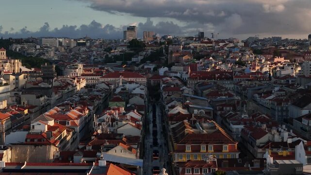 Aerial view of Praca do Comercio and the dense red rooftops of the Baixa district under a cloudy sky in Lisbon, Lisbon, Portugal.