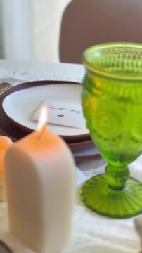 Cozy holiday preparation scene with a person organizing a beautifully decorated dining table.
