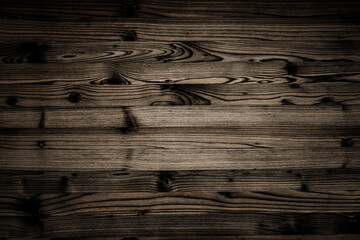 Wood planks arranged closely together to show grain patterns and textures in dim lighting © Fleuronica