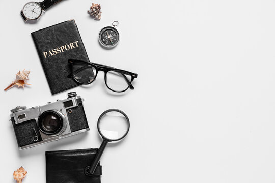 Composition with passport, photo camera and accessories on white background, closeup