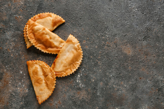 Tasty chebureks on grey grunge table