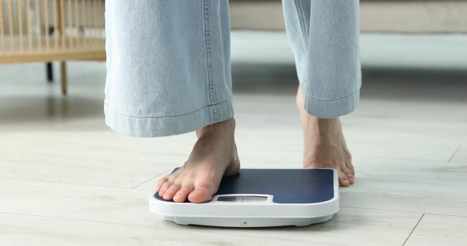 Anorexia. Woman standing on scales indoors, closeup