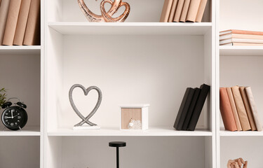 Shelves with books and stylish decor, closeup © Pixel-Shot
