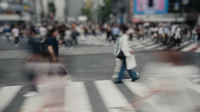 Anonymous crowd walking on shibuya crossing in tokyo