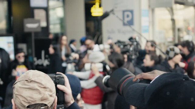 Photographers and journalists crowding a public event