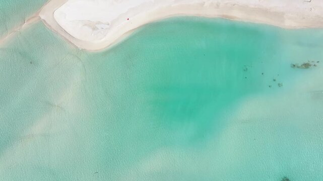 Aerial view of the white sand beach and turquoise lagoon waters with coral patches Fulhadhoo, Baa Atoll, Maldives.