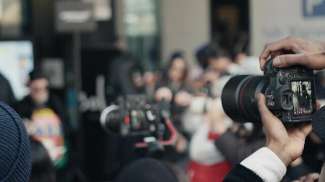 Photographer shooting with a camera at a crowded event