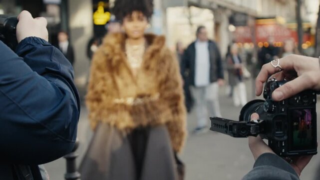 Photographers taking pictures of a famous celebrity on the street