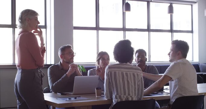 Manager woman, meeting and business people conversation, collaboration and planning creative project development. Group brainstorming process, creativity and mature team leader answer staff questions