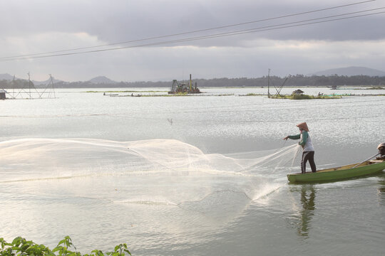 Peaceful Day at a Lake with Fish Farms and a Fisherman in Indonesia