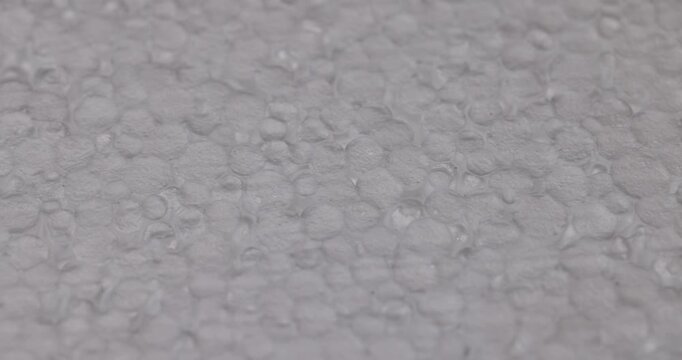 White foam with a dense texture, this synthetic foam is used as a packaging or construction insulator.