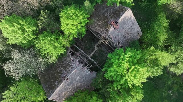 Aerial ruins historic manor house Poland descend inside. Drawsko northern Poland. Farm manor house in rural country farming landscape and economy. Abandoned after a century use, wealthy land owner.