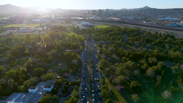 Wide aerial view of El Chamizal Federal Public Park in Ciudad Juarez, Chihuahua, Mexico. The image showcases the expansive green area with numerous trees, walking paths, and recreational spaces.