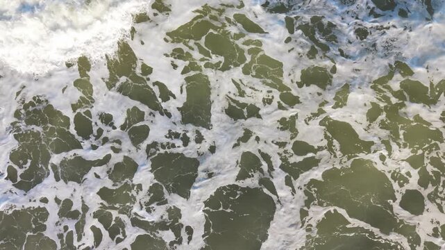 Ocean Foam Mosaic. Sea Foam With Honeycomb Pattern. Textural Ocean Surface With Honeycomb Shapes And Shadows. Aerial View Of Foam Textures Resembling Honeycomb Patterns In Ocean