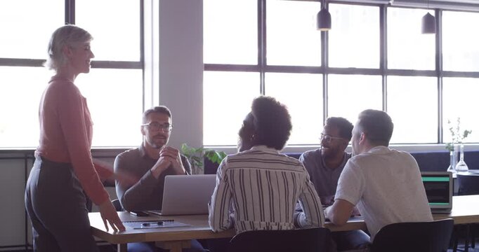Manager meeting, happy woman and business people discussion, collaboration and planning design ideas. Management, conversation and professional designer, group or team consulting on agency project
