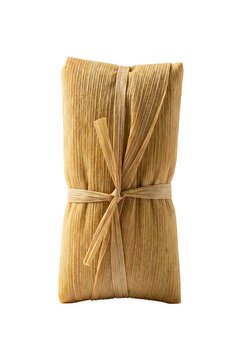 Traditional pamonha wrapped in corn husk isolated