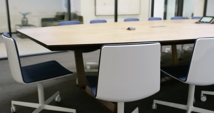 Empty, meeting room and table in workplace with furniture for business, career and workspace. Office space, seat and interior design of conference, workshop venue or chair with corporate company