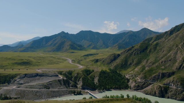 Drone footage of the confluence of the Chuya and Katun rivers, turquoise water winding through a mountain valley near Inya, Altai Republic, Russia