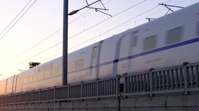Railway Bridge with Overhead Power Lines at Sunset