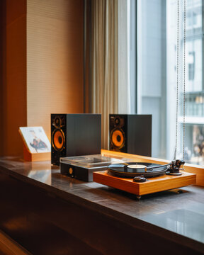 Modern Turntable Audio System with Speakers by Window, Stylish Music Listening Setup in Warm Interior