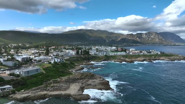 Approaching aerial view with seaside cliffs in Hermanus in South Africa.