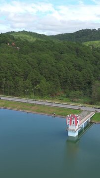 Tuyen Lam Lake dam in Da Lat, Vietnam, offers scenic views with paddle boats docked and people enjoying a walk along the promenade. , Da Lat, Vietnam.