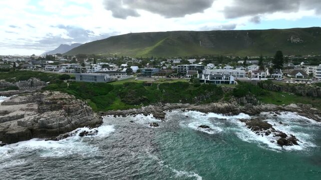 Approaching aerial drone view from the sea to Hermanus, South Africa.