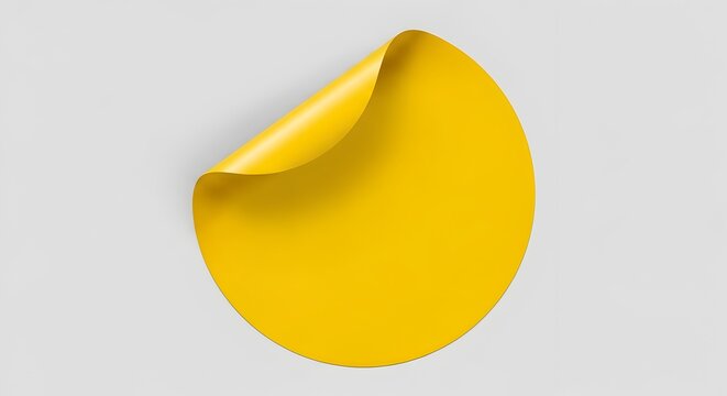 Yellow sticker with curled corner on gray background