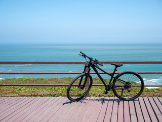Fototapeta premium Mountain Bike by the Ocean Boardwalk