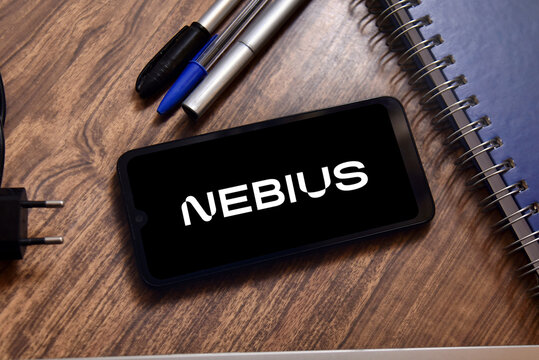 Nebius Group logo on a smartphone screen on an office desk. Technology company  that provides artificial intelligence infrastructure.