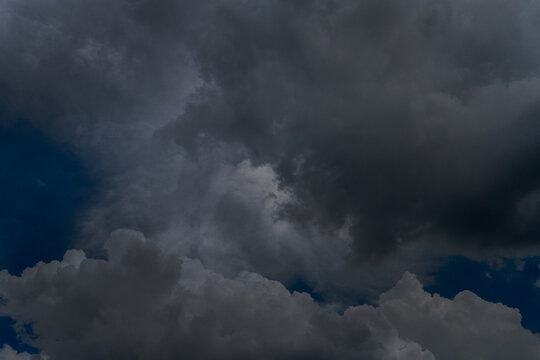Dark thunderstorm clouds rainny season. Meteorology danger windstorm disasters climate. Banner Dramatic dark storm clouds black sky background. Dark thunderstorm clouds rainny atmosphere.