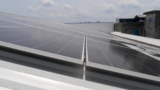 Solar panels installed on industrial warehouse roof generating renewable energy