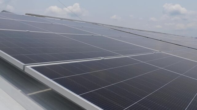 Solar panels installed on industrial warehouse roof generating renewable energy