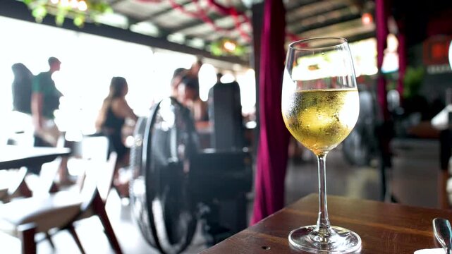 Chilled Glass of White Wine on a Sunny Outdoor Restaurant Patio