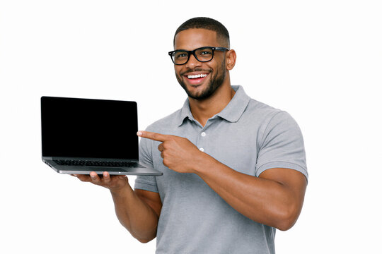 young man working on laptop and is pointing at the screen on white