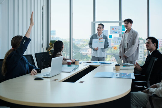 Young company coworkers explain finance and marketing investment analysis, team questions, ask, discuss, and brainstorm with multiracial partners in meeting and business strategy report presentations.