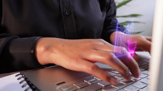 Monitoring e-commerce results. Close-up view of an executive typing on her laptop with a virtual icon of a shopping cart graph.