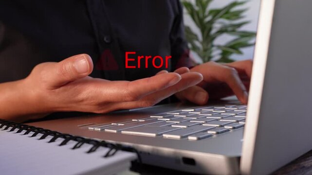 Close-up of a businesswoman's hands working on her laptop while holding an "Error" animation with warning signs. Warning of a computer error