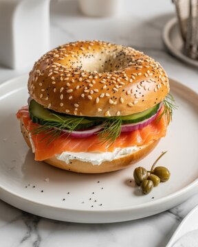Smoked salmon bagel on white plate cream cheese capers