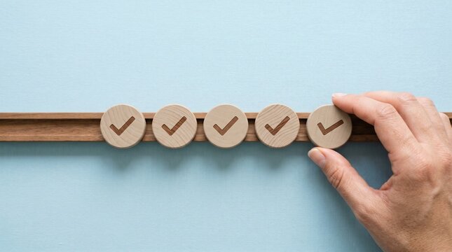 Completing Tasks: A close-up shot of a hand placing a wooden disc with a check mark, indicating the finalization of a task. This image speaks to productivity, success, and the completion of goals.