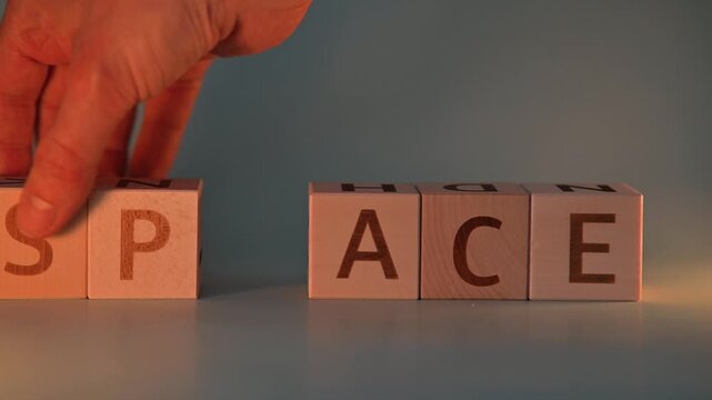 A hand moves letter blocks to change the words from peace to pace and then to space. This action highlights the significance of language and its variations in meaning
