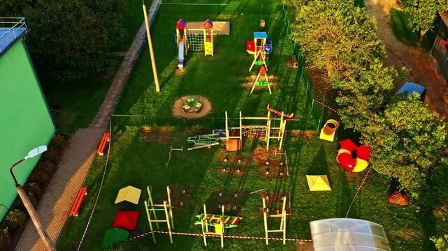 Children playground under construction with different play equipment, slides, swings, and climbing structures