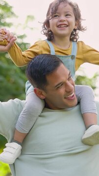 Outdoor, father and girl on shoulder, happiness and bonding together with holiday, care and funny. Bokeh, dad and daughter with game, flying and playing with growth development, child and humor