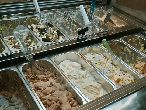Close up of various flavors of gelato ice-cream at the showcase in dessert shop.