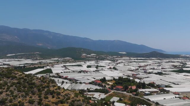 Demre, Turkey. Ancient Myra amphitheater surrounded by modern elements showing historical continuity in landscape. Aerial View, MasterShots, Tilt up, Tilt down