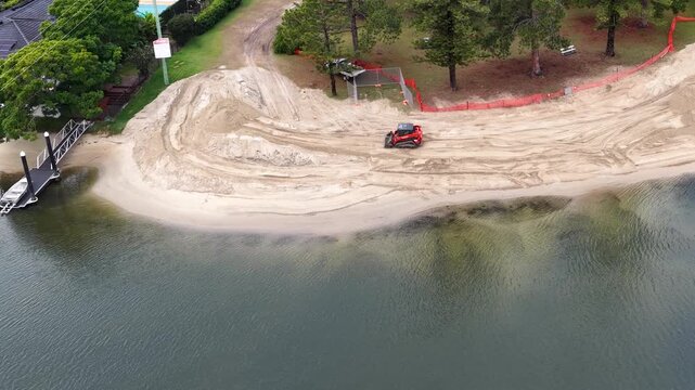 Aerial View of Excavator Renovating a Canal Beach in Gold Coast