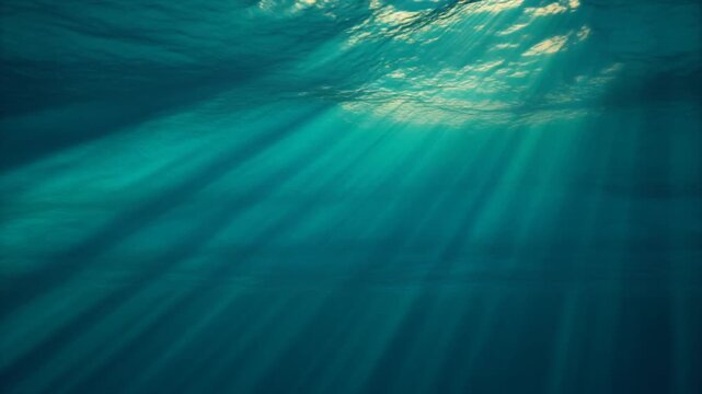 Seamless Loop of Sun Rays Penetrating Clear Blue Ocean Water, Cinematic Full HD Motion Background
