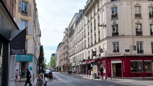 Pedestrians and Traffic on a Classic Haussmann Street in Paris